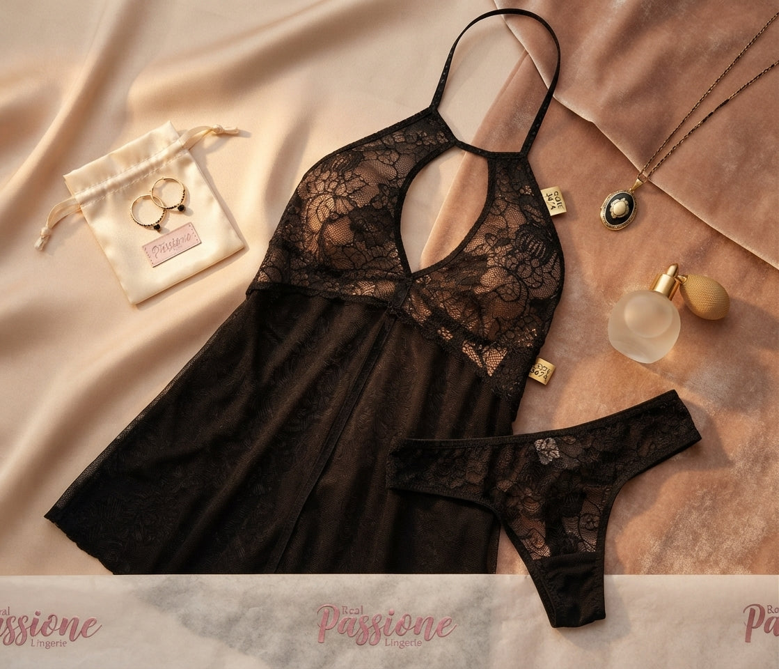 Flat lay of Passione code black lace-trim slip nightwear set with Soft Secrets branding, gold mirror, and rose petals.
