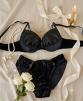 Luxury Black Ring Foam Bra & Panty Set in a premium flat lay with floral accents, showcasing padded cups, embroidered design, and matching panties for everyday comfort and style.
