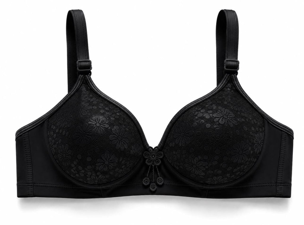 Black wireless floral lace foam bra featuring padded cups, a central floral applique dangle charm, and adjustable wide side wings on a white background.